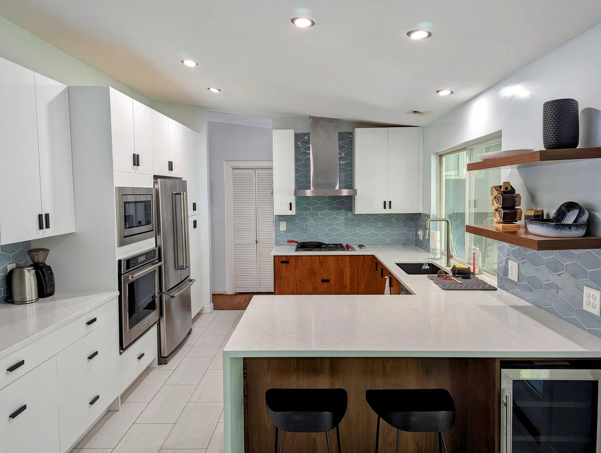 Modern kitchen renovation featuring white cabinets, granite countertops, and professional craftsmanship